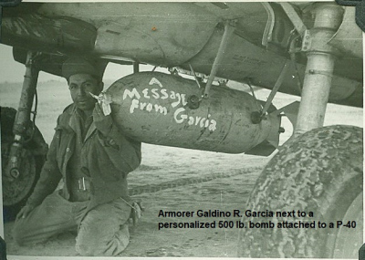 1_85th-FS-armorer-Galdino-Garcia-with-500-lb-bomb-on-a-P-40.-Jacob-Schoellkopf-collection-via-Ian-Lyn