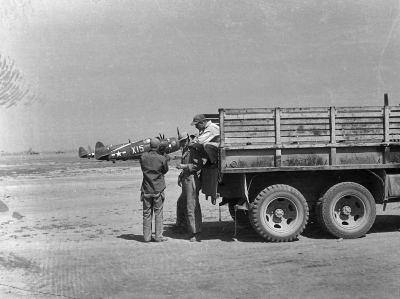 Unidentified-on-truck-with-85th-FS-P-47s-in-background.-Henry-O.-Tomlin-collection-via-Jeanette-Tomlin