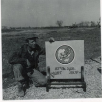 85th-FS-Paint-shop-sign-with-unidentified-individual.-Elven-G.-Hubbard-collection-via-his-family