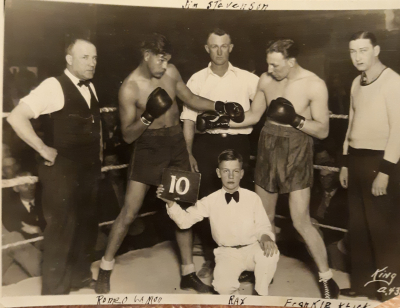 86th-FS-Romie-R.-Royse-earning-money-holding-up-boxing-round-cards-via-the-Royse-family