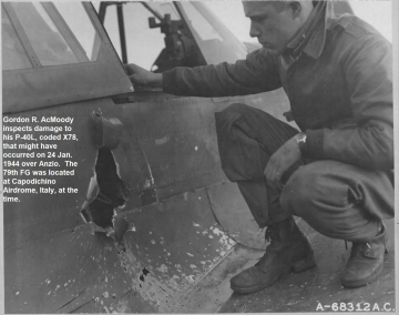 87th-FS-Gordon-AcMoody-inspecting-P-40-damage.-USAAF-photograph1